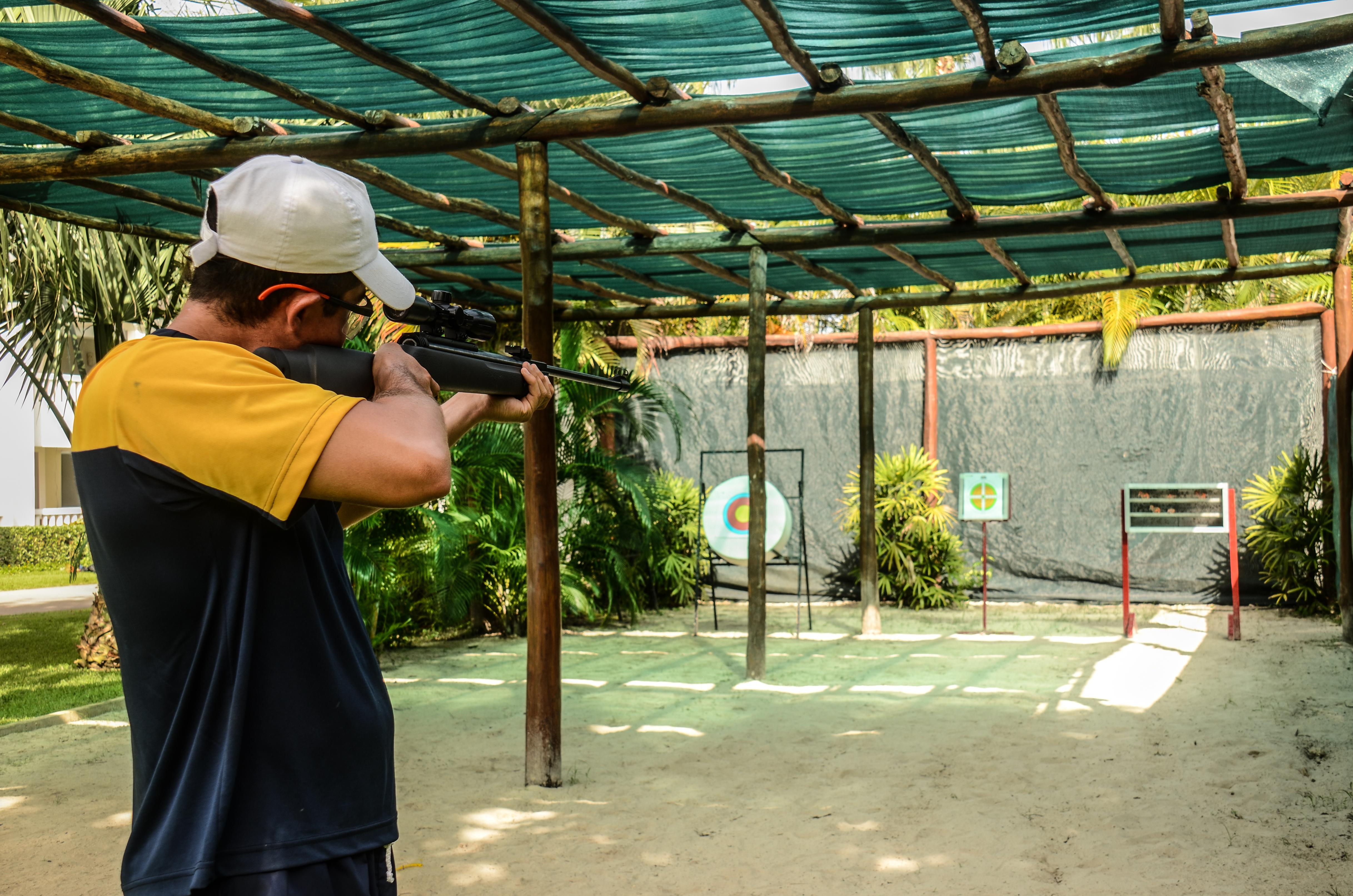 Grand Sunset Princess Playa del Carmen Exterior photo A man shooting a rifle at a target